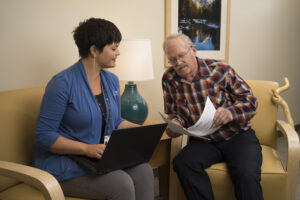 women explaining process to older man