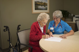 Young woman doctor with senior old lady